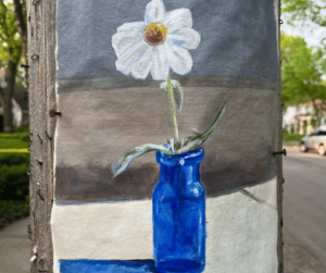 A flyer on a light post that is of a painted white flower in a blue vase. 